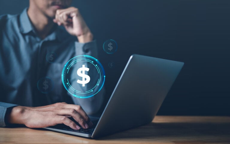 man looking at compensation package on his laptop