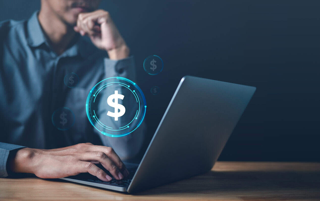man looking at compensation package on his laptop